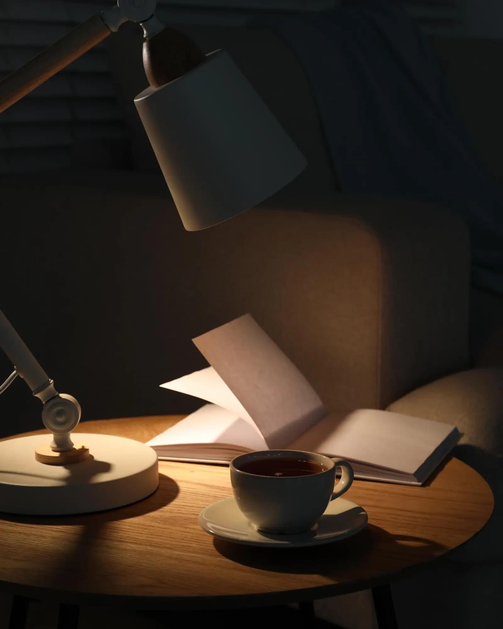 A notebook and lamp on a quiet evening desk.