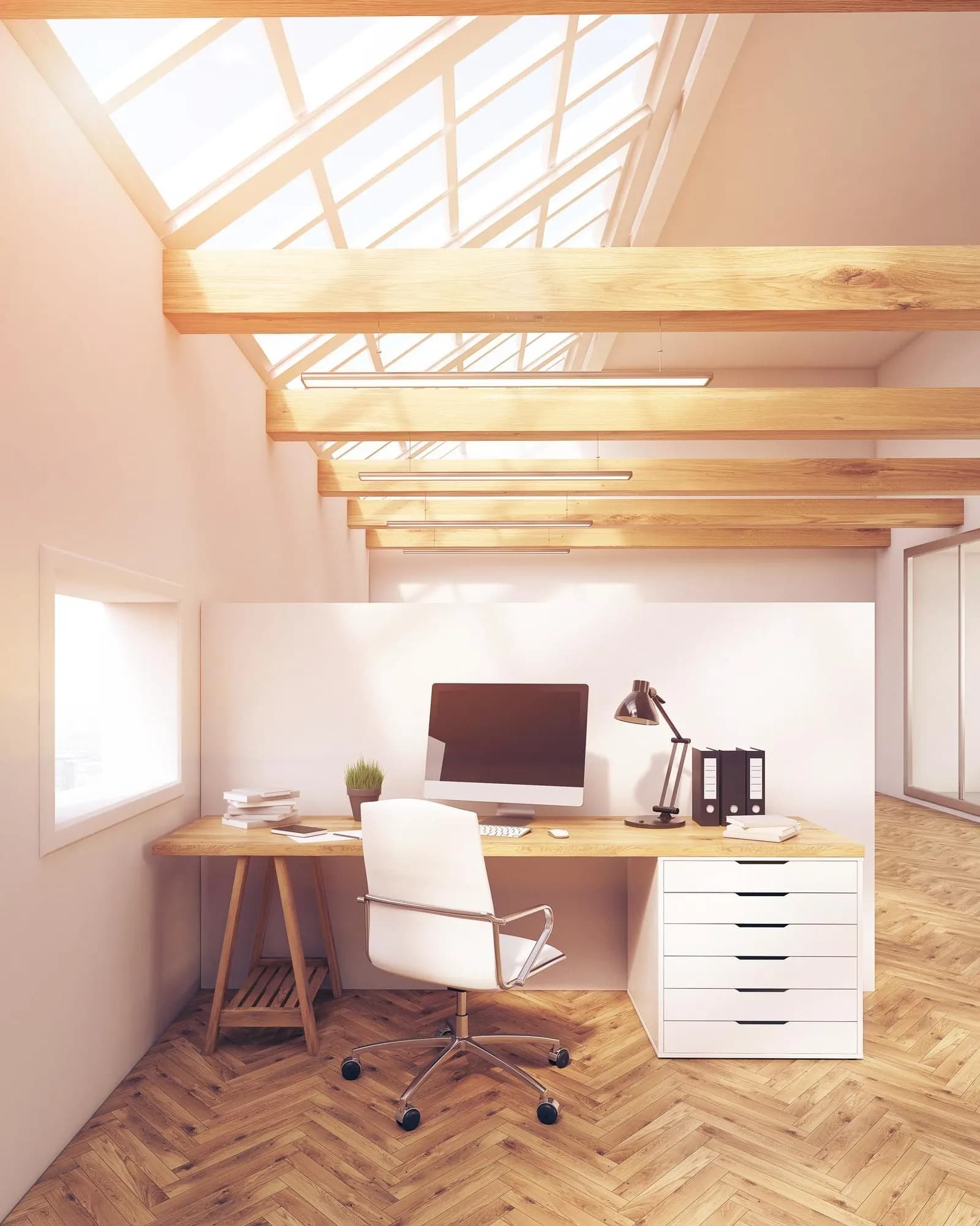 An empty design studio with desks in warm daylight.