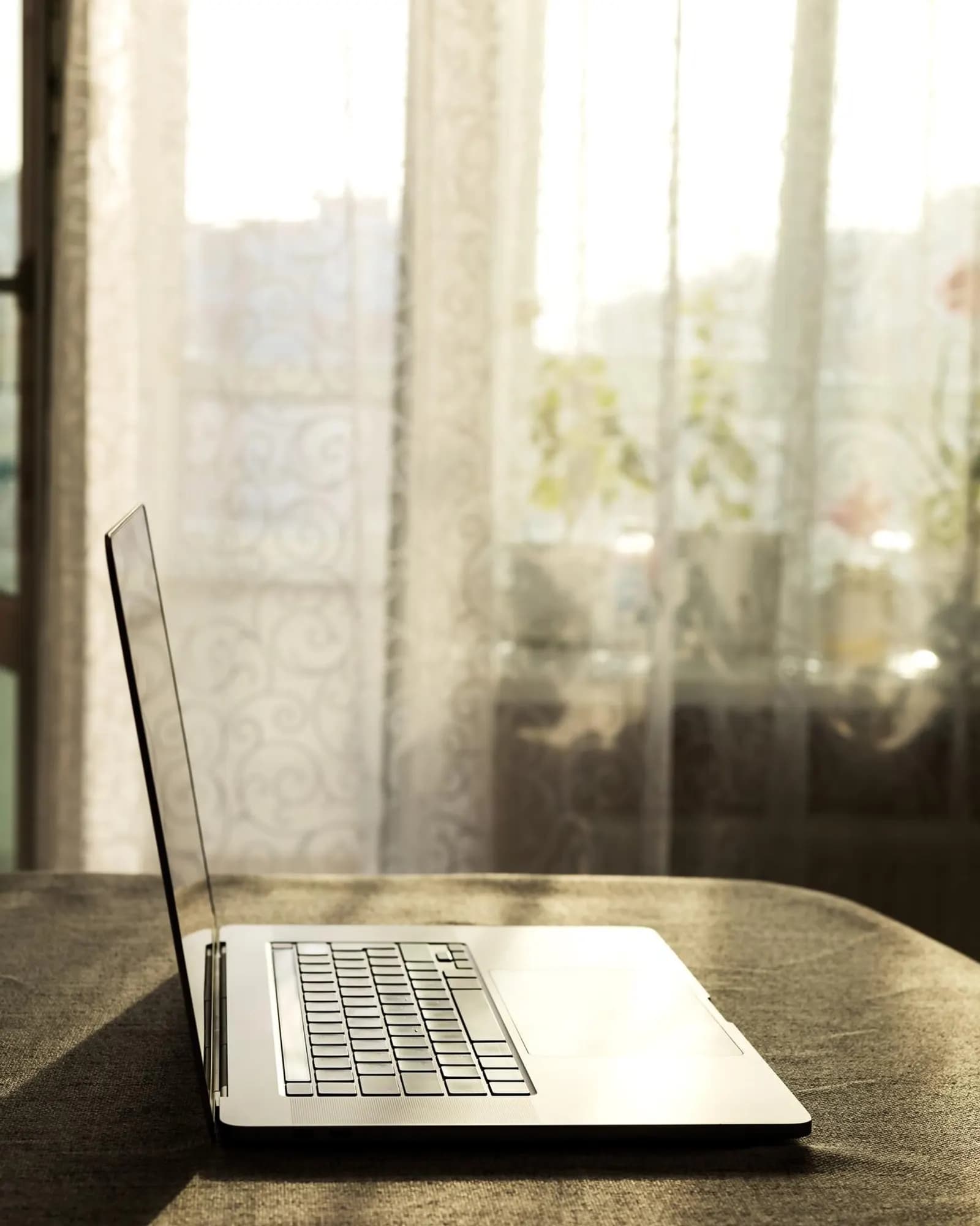 A laptop on a clean product desk in natural light.